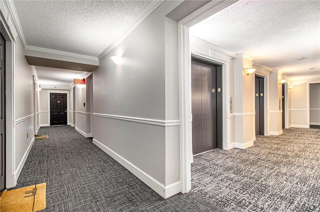 795 Hammond Drive, Unit 206 Atlanta, GA 30328 - Photo 21 of 29 a view of hallway with wooden floor