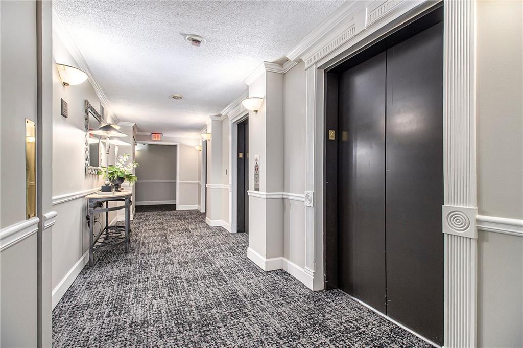 795 Hammond Drive, Unit 206 Atlanta, GA 30328 - Photo 22 of 29 a kitchen with a refrigerator and a sink