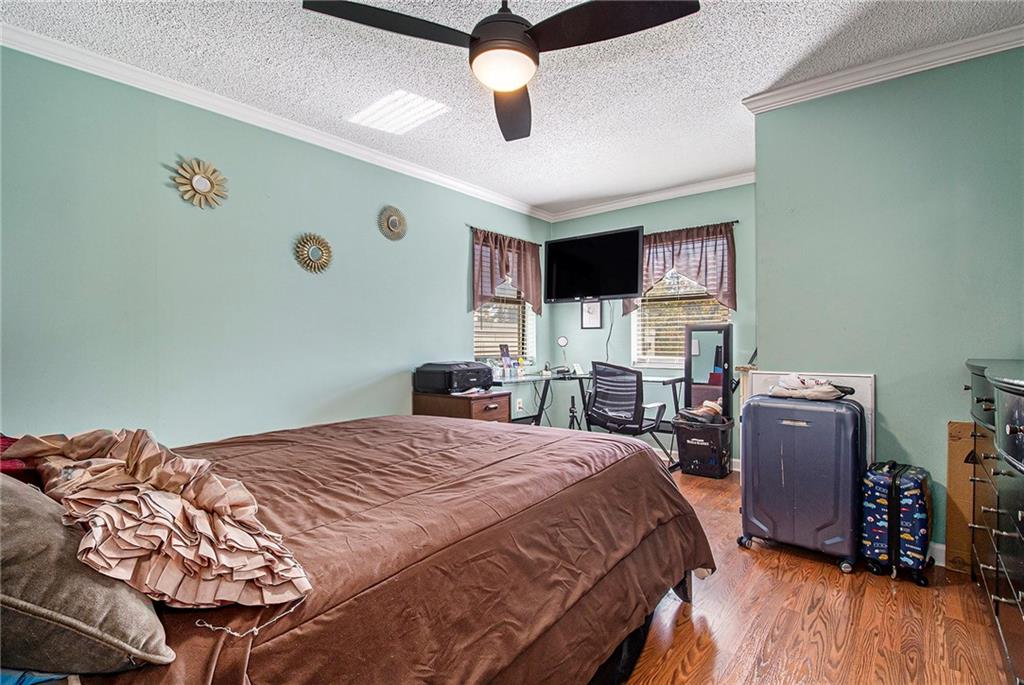 795 Hammond Drive, Unit 206 Atlanta, GA 30328 - Photo 23 of 29 a bedroom with a bed and wooden floor