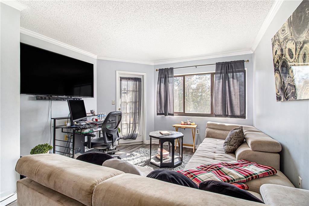 795 Hammond Drive, Unit 206 Atlanta, GA 30328 - Photo 3 of 29 a living room with furniture and a flat screen tv