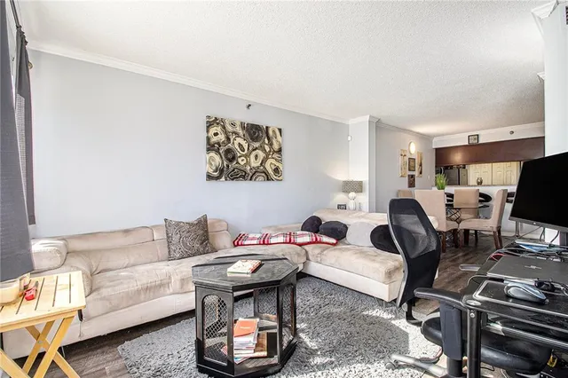 a kitchen with stainless steel appliances a dining table chairs and wooden floor
