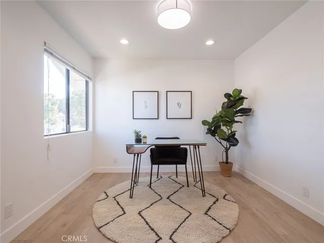 a work room with furniture and a potted plant