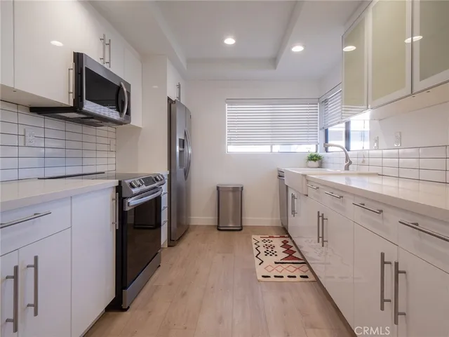 a kitchen with a sink stove and microwave