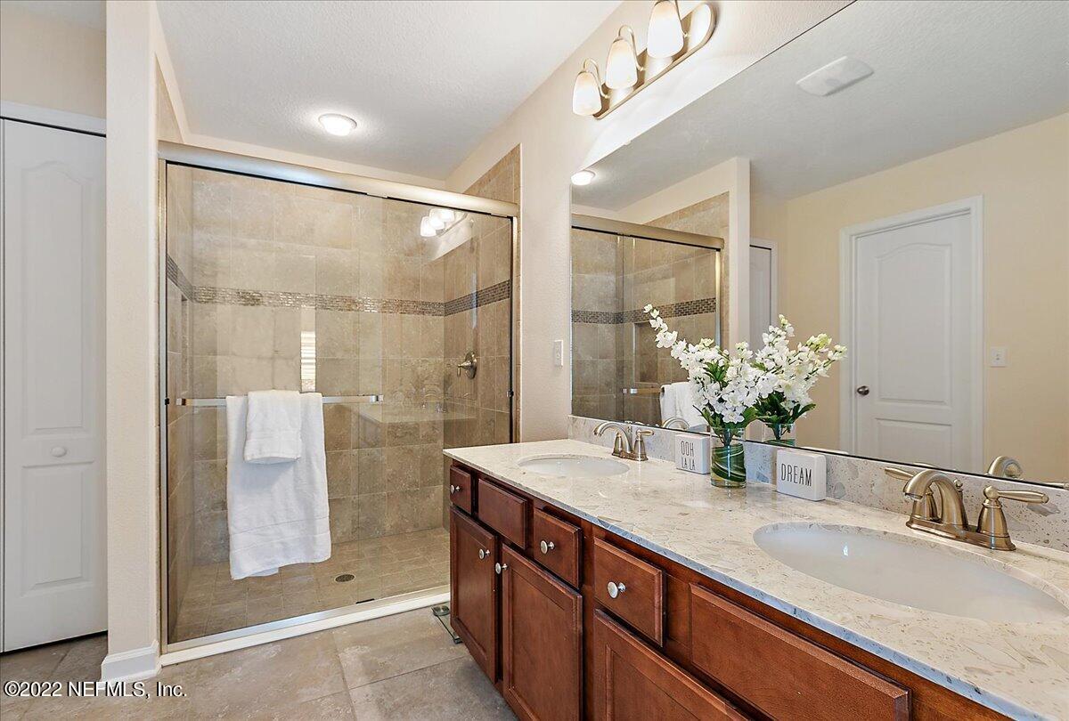 120 Toscana Lane St. Augustine, FL 32092 - Photo 13 of 29 a bathroom with a granite countertop shower sink and mirror