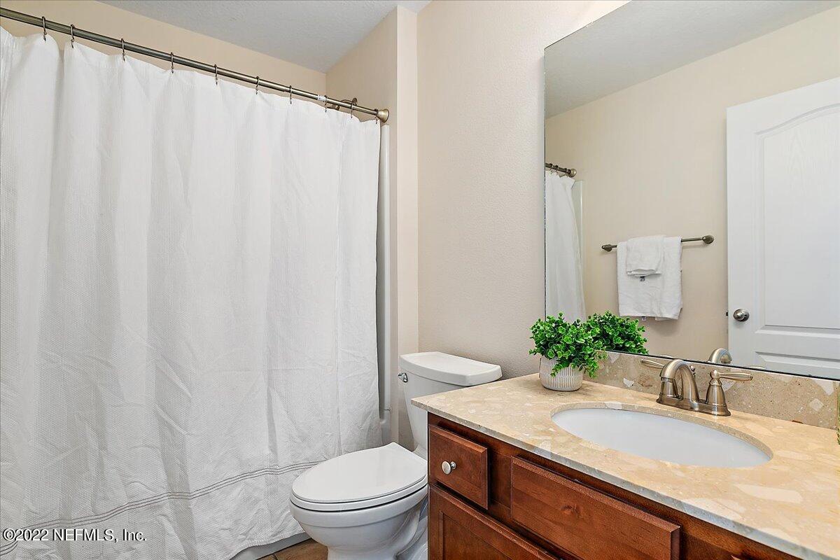 120 Toscana Lane St. Augustine, FL 32092 - Photo 15 of 29 a bathroom with a granite countertop sink and a mirror