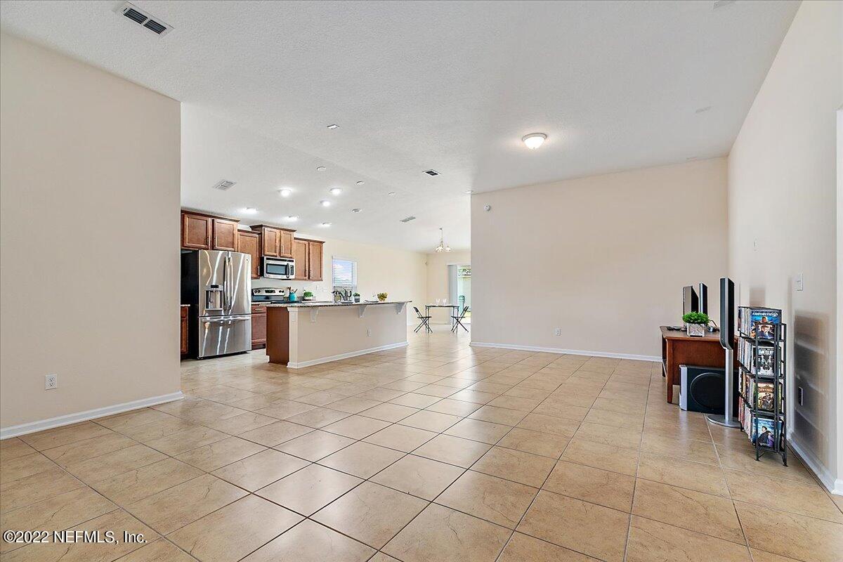 120 Toscana Lane St. Augustine, FL 32092 - Photo 5 of 29 a view of kitchen with kitchen island stainless steel appliances refrigerator sink and cabinets