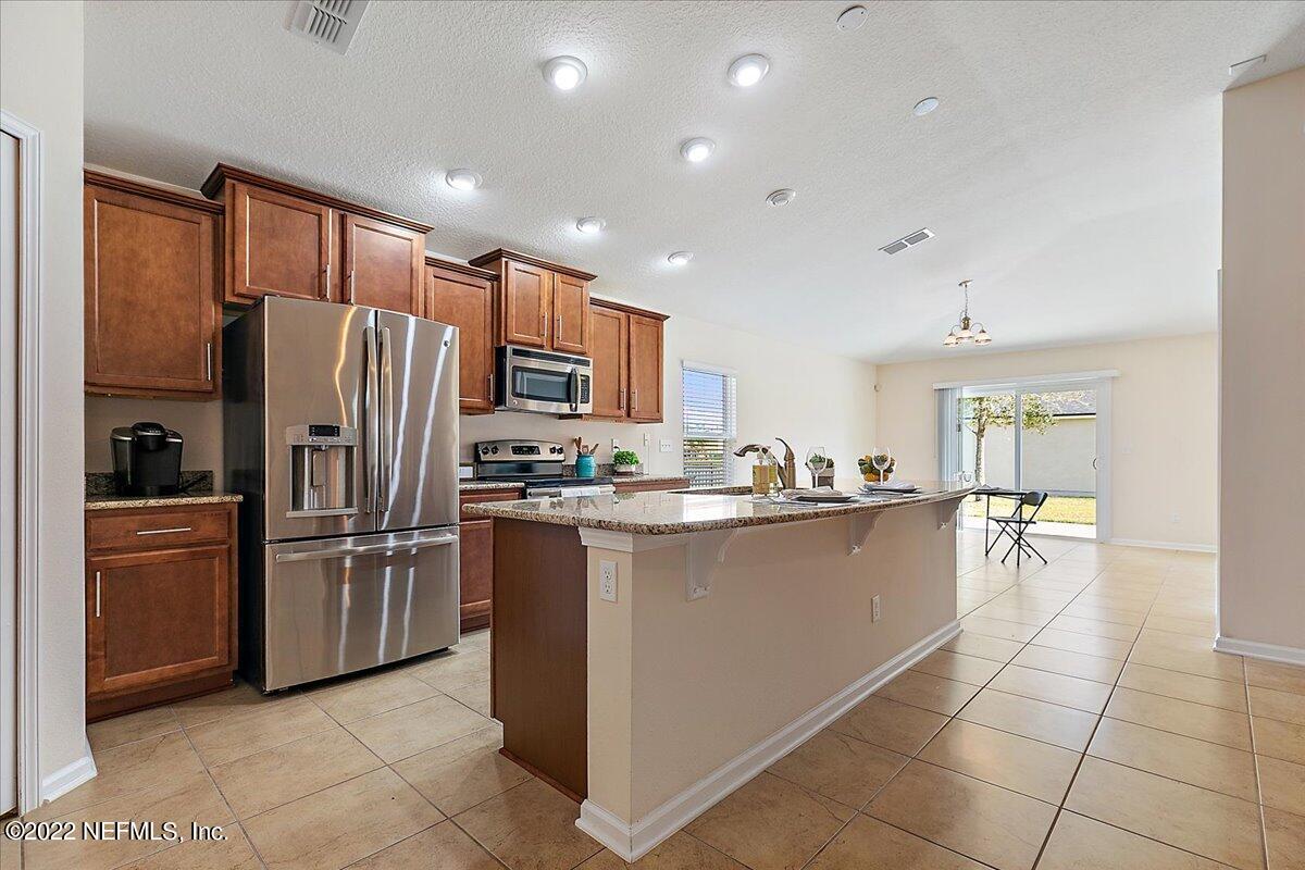 120 Toscana Lane St. Augustine, FL 32092 - Photo 6 of 29 a kitchen with stainless steel appliances a refrigerator sink and cabinets