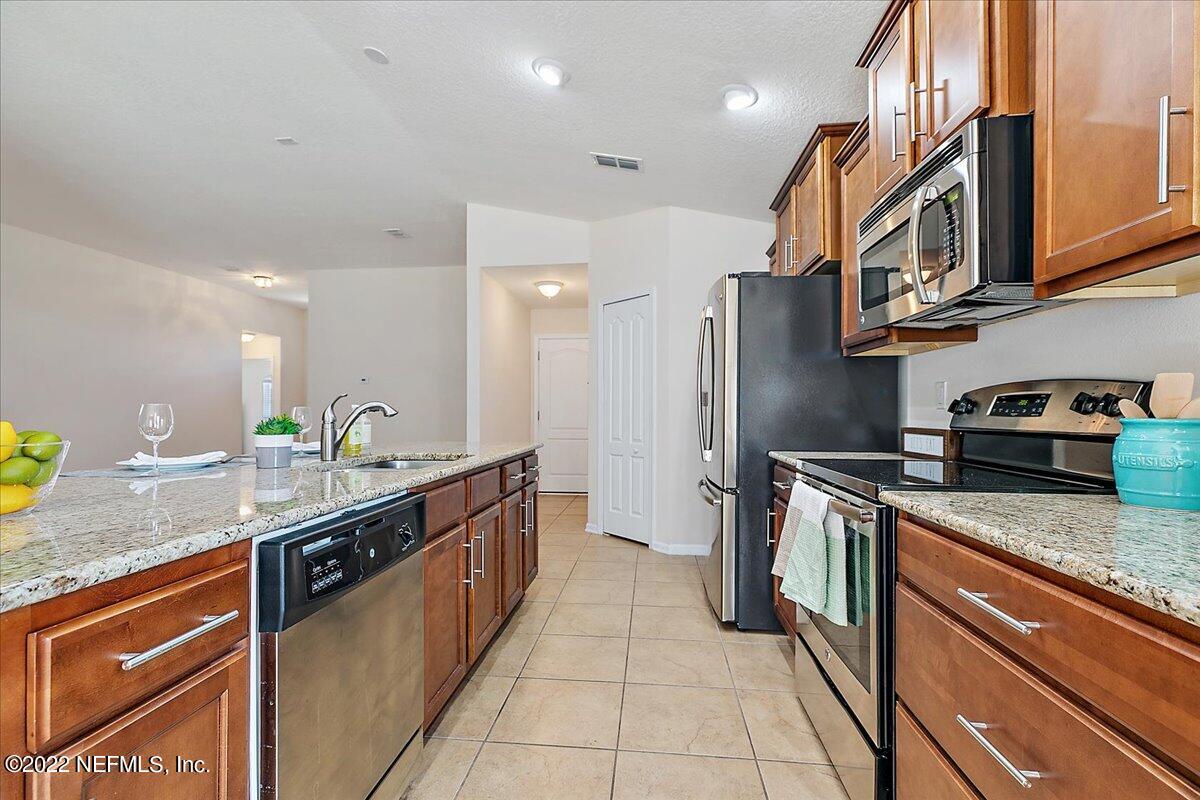 120 Toscana Lane St. Augustine, FL 32092 - Photo 9 of 29 a kitchen with stainless steel appliances granite countertop a sink and a stove