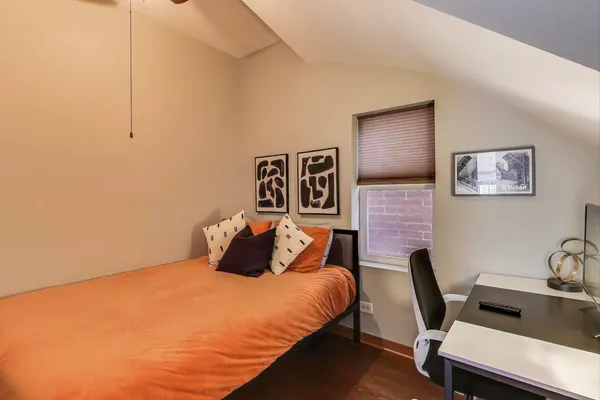 a bedroom with a bed and wooden floor