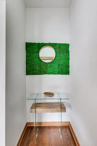 a view of a room with wooden floor and white walls