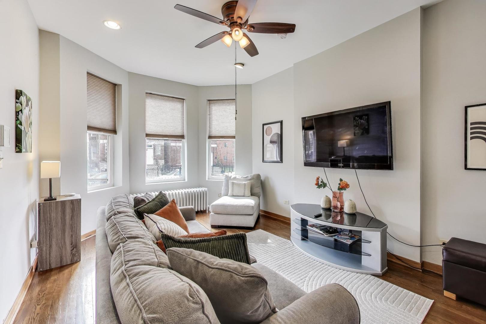 2720 West Polk Street, Unit 1 Chicago, IL 60612 - Photo 3 of 13 a living room with furniture and a flat screen tv