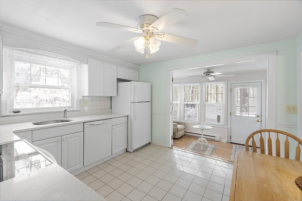 18 Frank Street Chelmsford, MA 01863 - Photo 15 of 38 a large white kitchen with a window a sink and a refrigerator