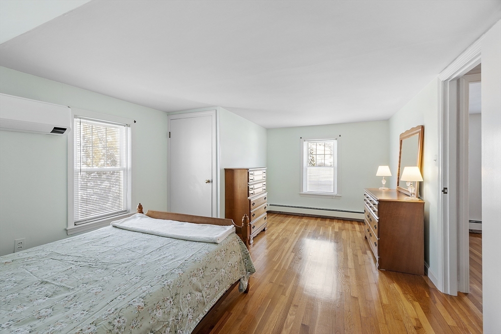 18 Frank Street Chelmsford, MA 01863 - Photo 17 of 38 a bedroom with a bed and wooden floor