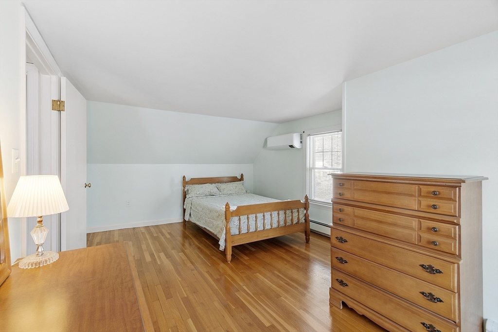 18 Frank Street Chelmsford, MA 01863 - Photo 18 of 38 a bedroom with a bed and a lamp on dresser