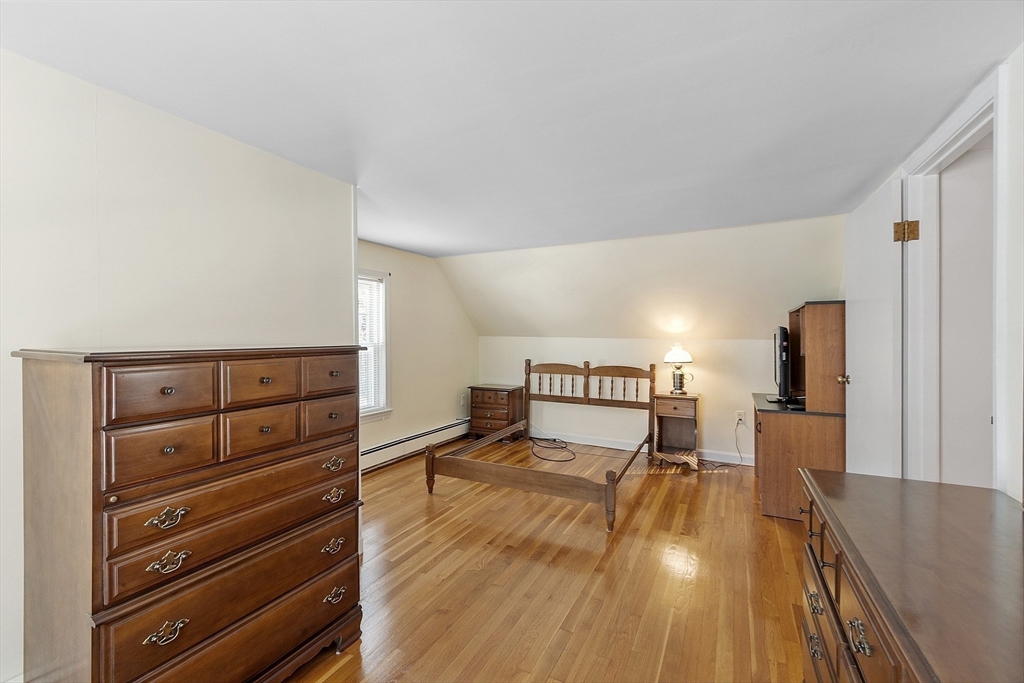 18 Frank Street Chelmsford, MA 01863 - Photo 19 of 38 a bedroom with a bed and wooden floor