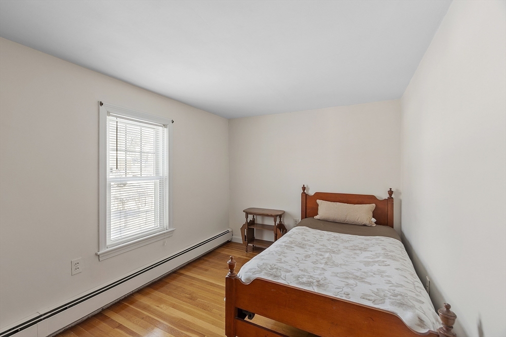 18 Frank Street Chelmsford, MA 01863 - Photo 21 of 38 a bedroom with a bed and wooden floor