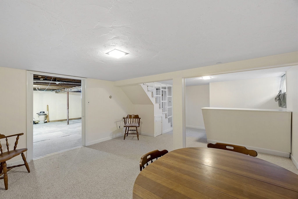 18 Frank Street Chelmsford, MA 01863 - Photo 28 of 38 a room with gym equipment and a table