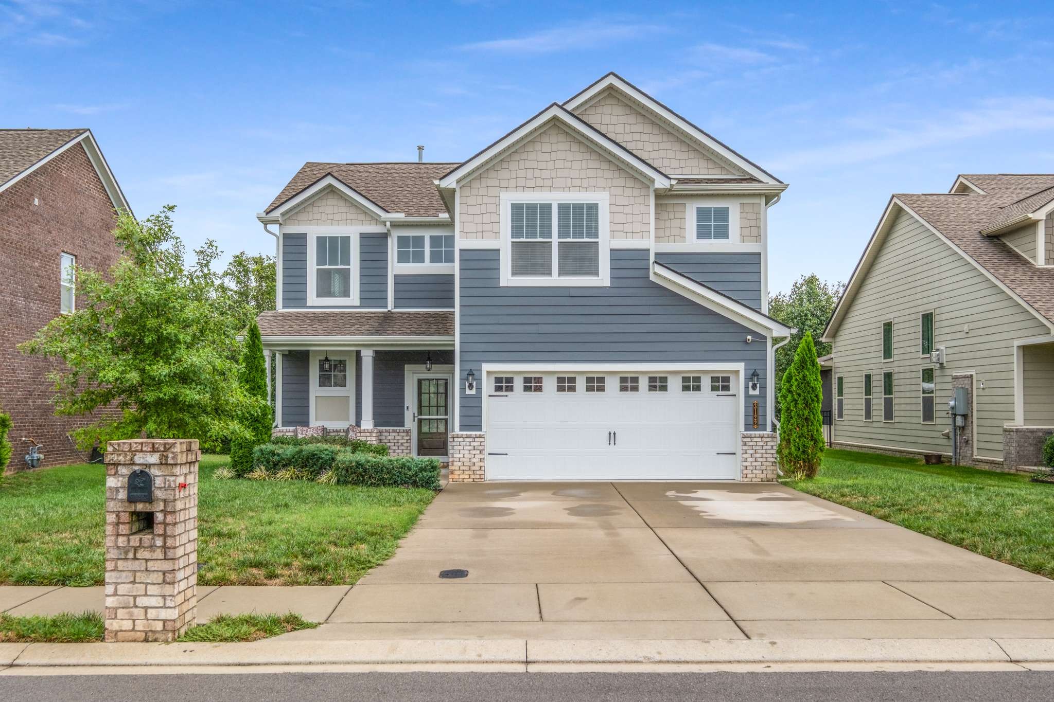 3122 Rift Lane Murfreesboro, TN 37130 - Photo 54 of 55 a view of a brick house with a yard plants and large tree