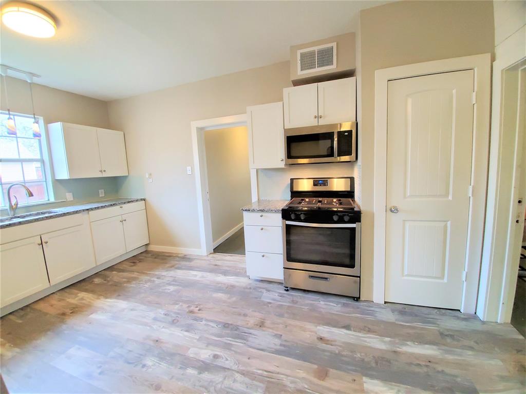 2223 North Locust Street Denton, TX 76209 - Photo 13 of 33 a kitchen with stainless steel appliances a stove and a refrigerator