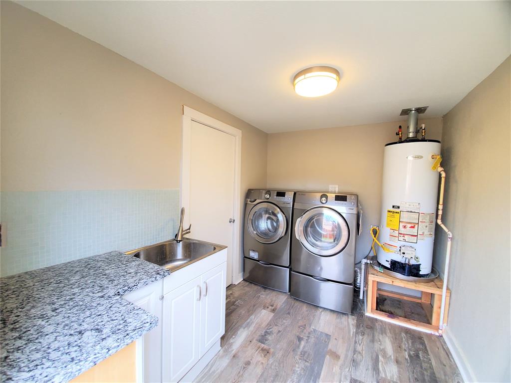 2223 North Locust Street Denton, TX 76209 - Photo 15 of 33 a utility room with sink dryer and washer