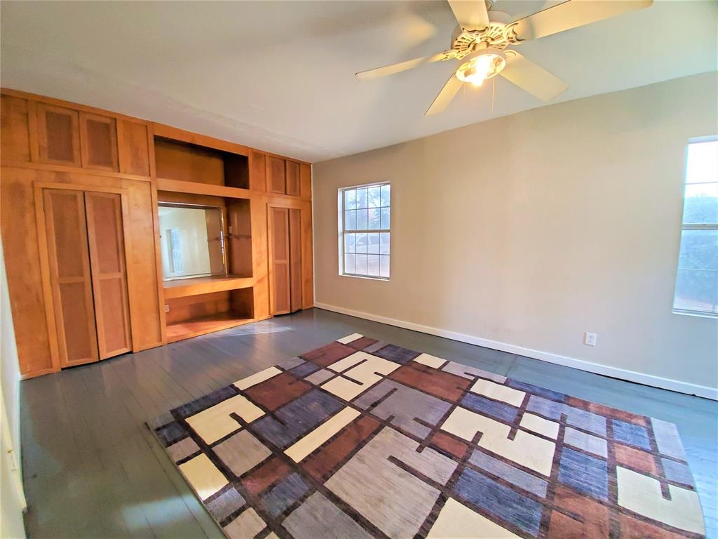 2223 North Locust Street Denton, TX 76209 - Photo 16 of 33 a view of an empty room with window and wooden floor