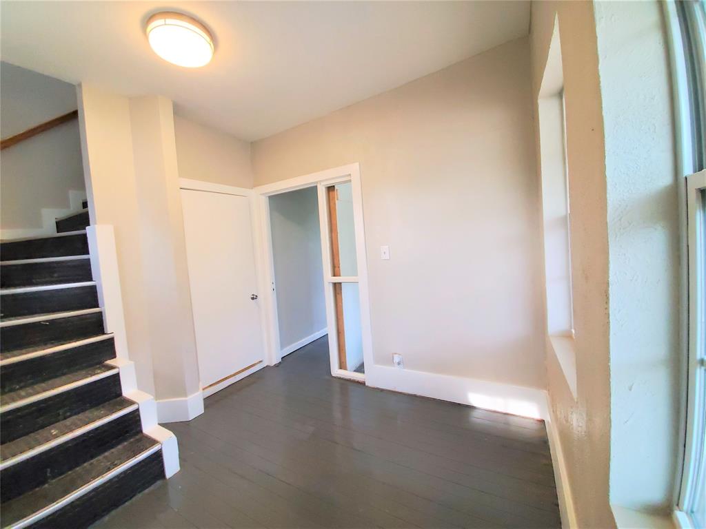 2223 North Locust Street Denton, TX 76209 - Photo 20 of 33 an empty room with wooden floor and windows