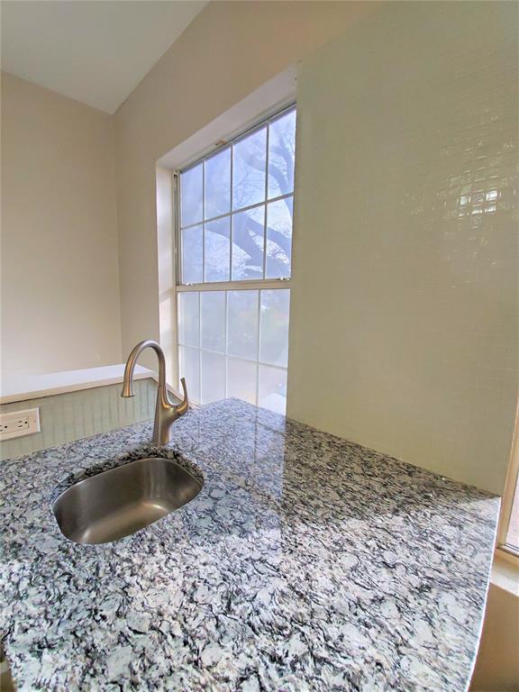 2223 North Locust Street Denton, TX 76209 - Photo 24 of 33 a bathroom with a sink a vanity and a window