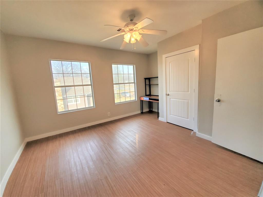 2223 North Locust Street Denton, TX 76209 - Photo 30 of 33 an empty room with wooden floor and windows
