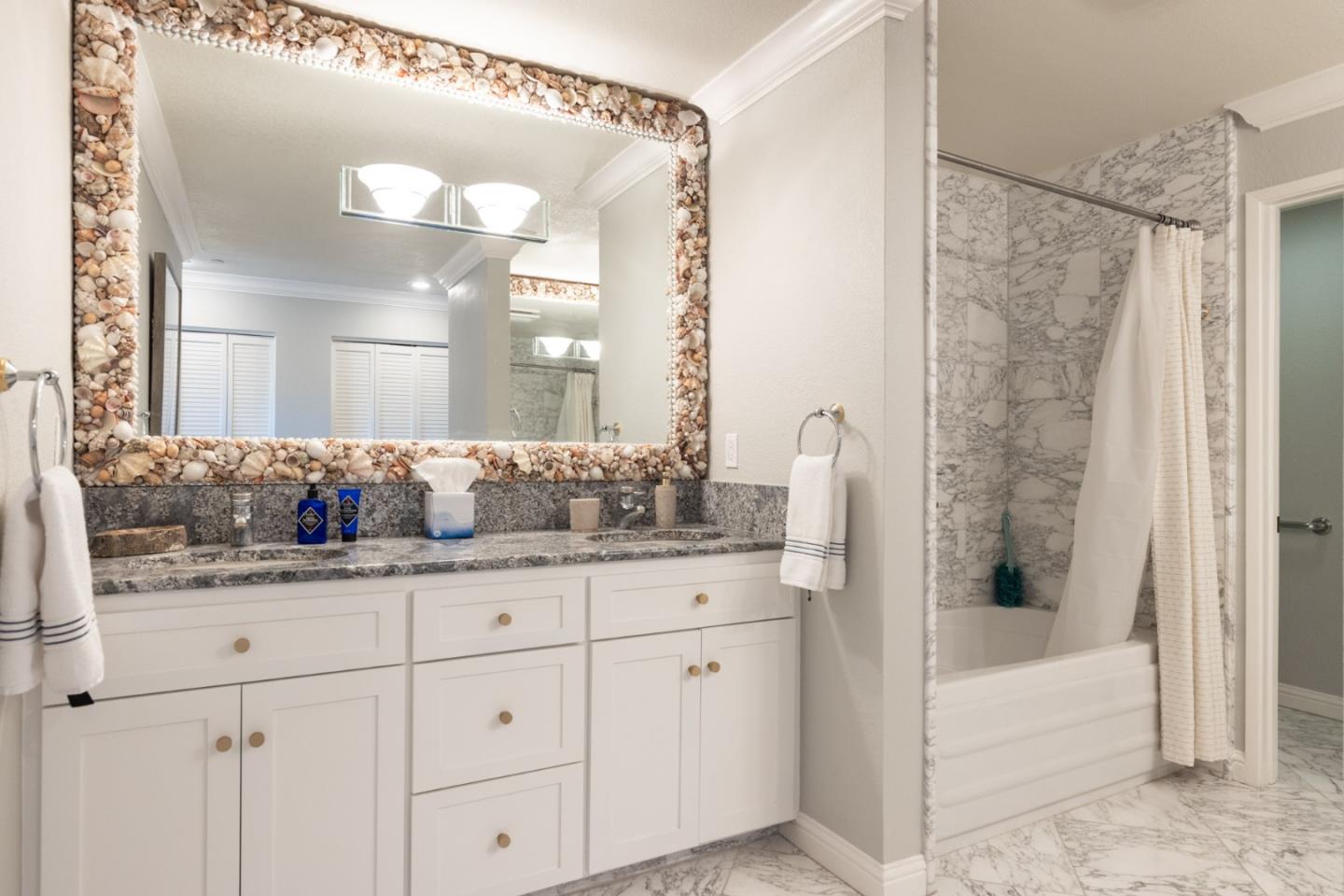 20 Shepherd's Knoll Pebble Beach, CA 93953 - Photo 12 of 23 a bathroom with a granite countertop sink and a mirror