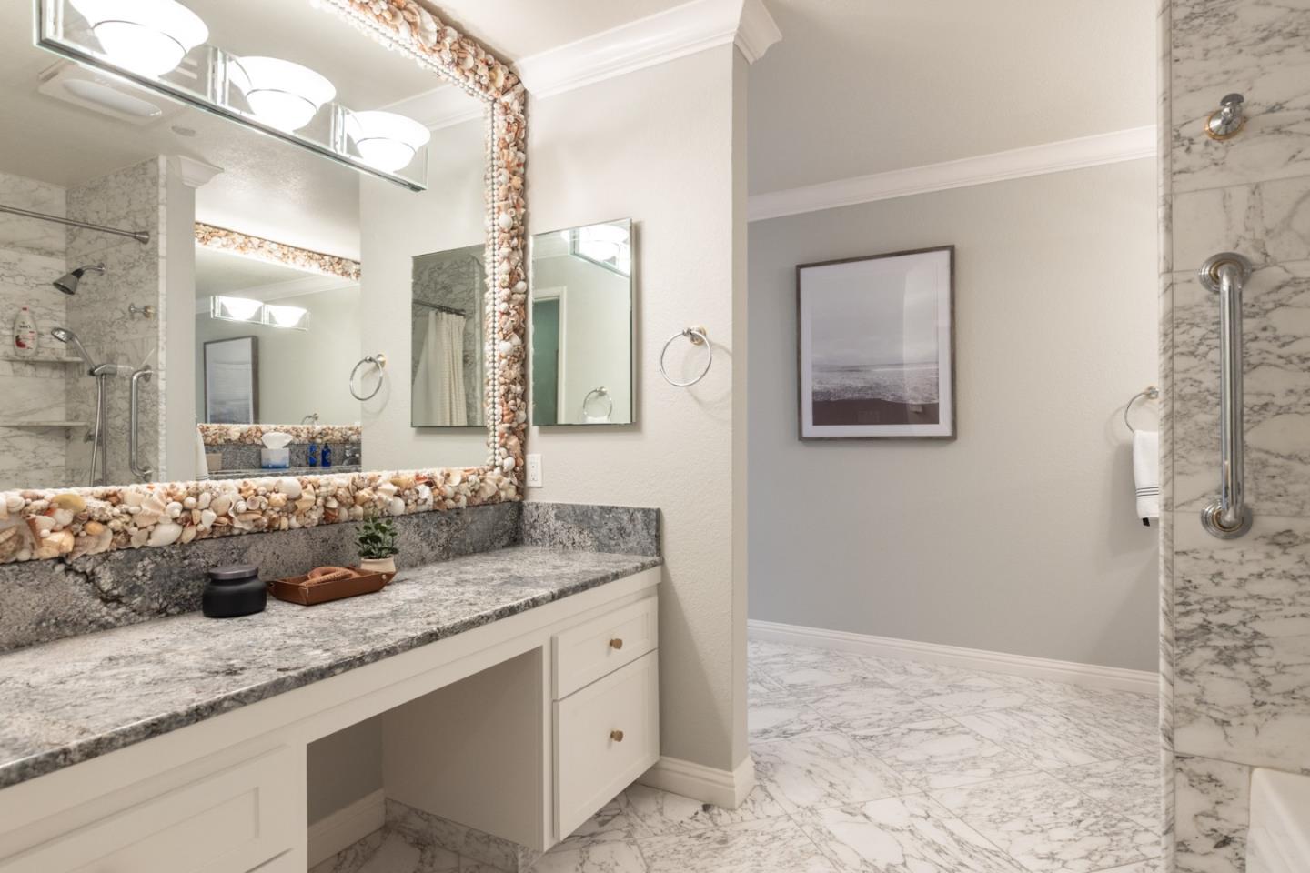 20 Shepherd's Knoll Pebble Beach, CA 93953 - Photo 13 of 23 a bathroom with a granite countertop sink a mirror and shower
