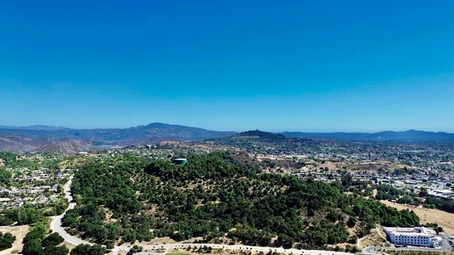 an aerial view of residential house with green space