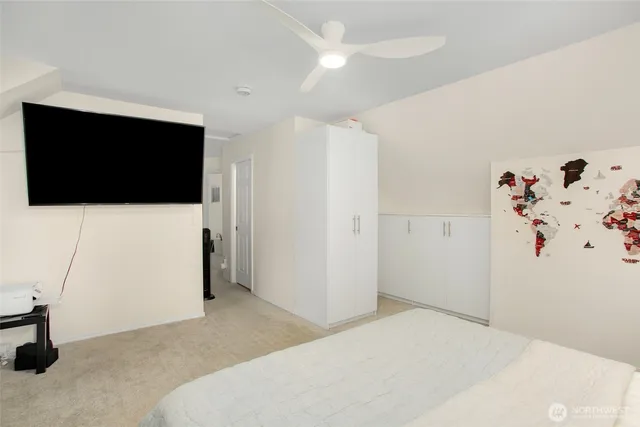 a bedroom with a bed and a flat screen tv