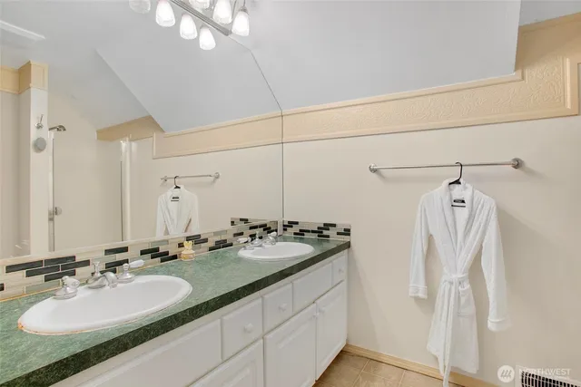 a bathroom with a double vanity sink and mirror