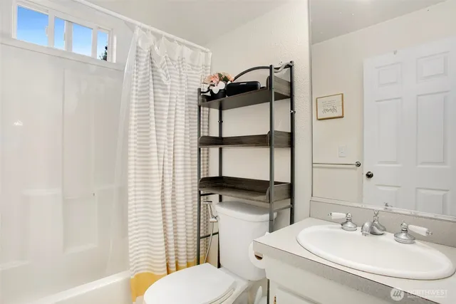 a bedroom with a bed and a desk