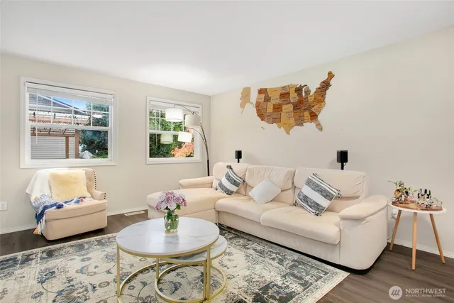 a living room with furniture and a potted plant