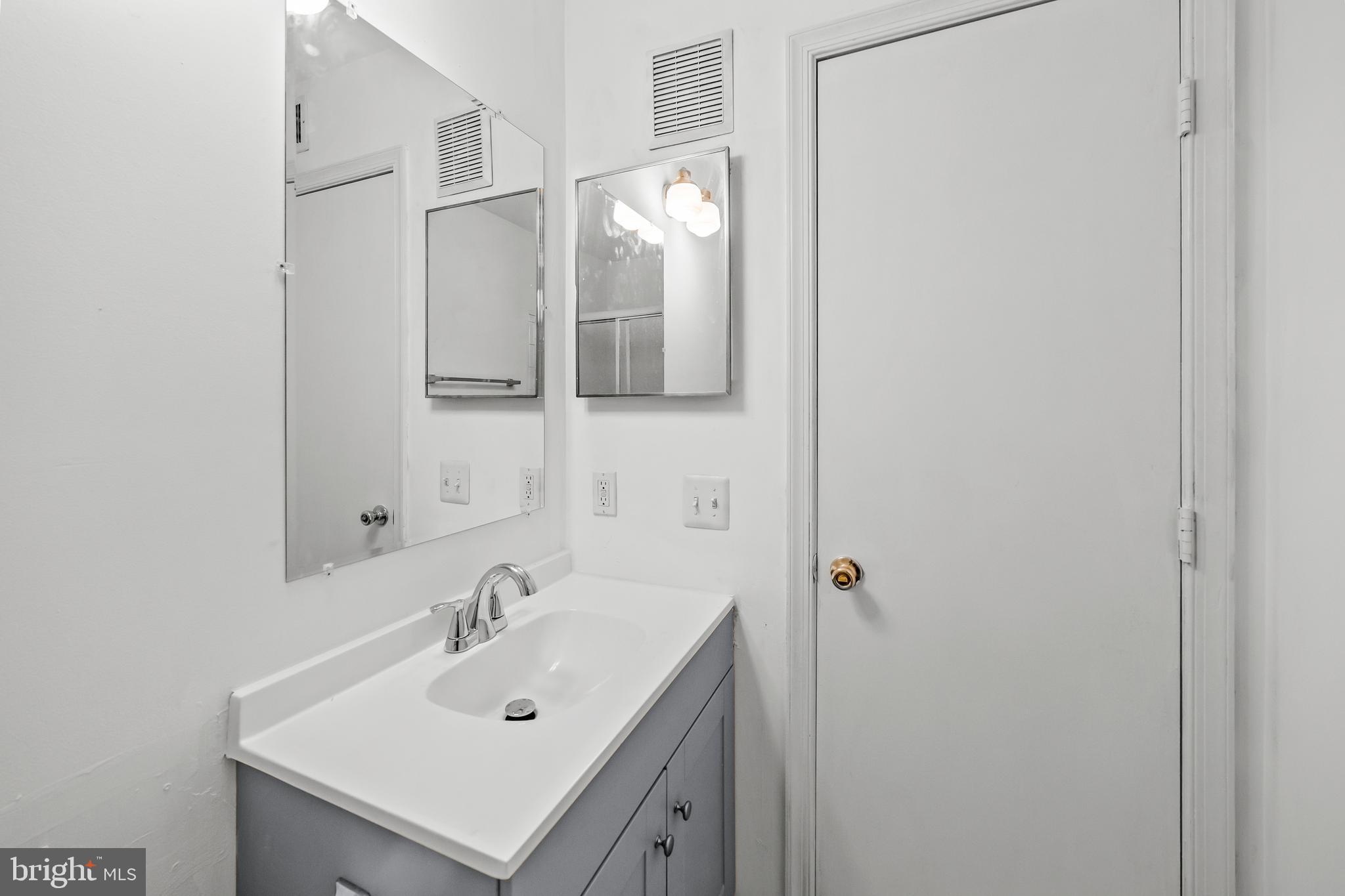 6 Normandy Square Court, Unit 2CF Silver Spring, MD 20906 - Photo 13 of 42 a bathroom with a sink and a mirror