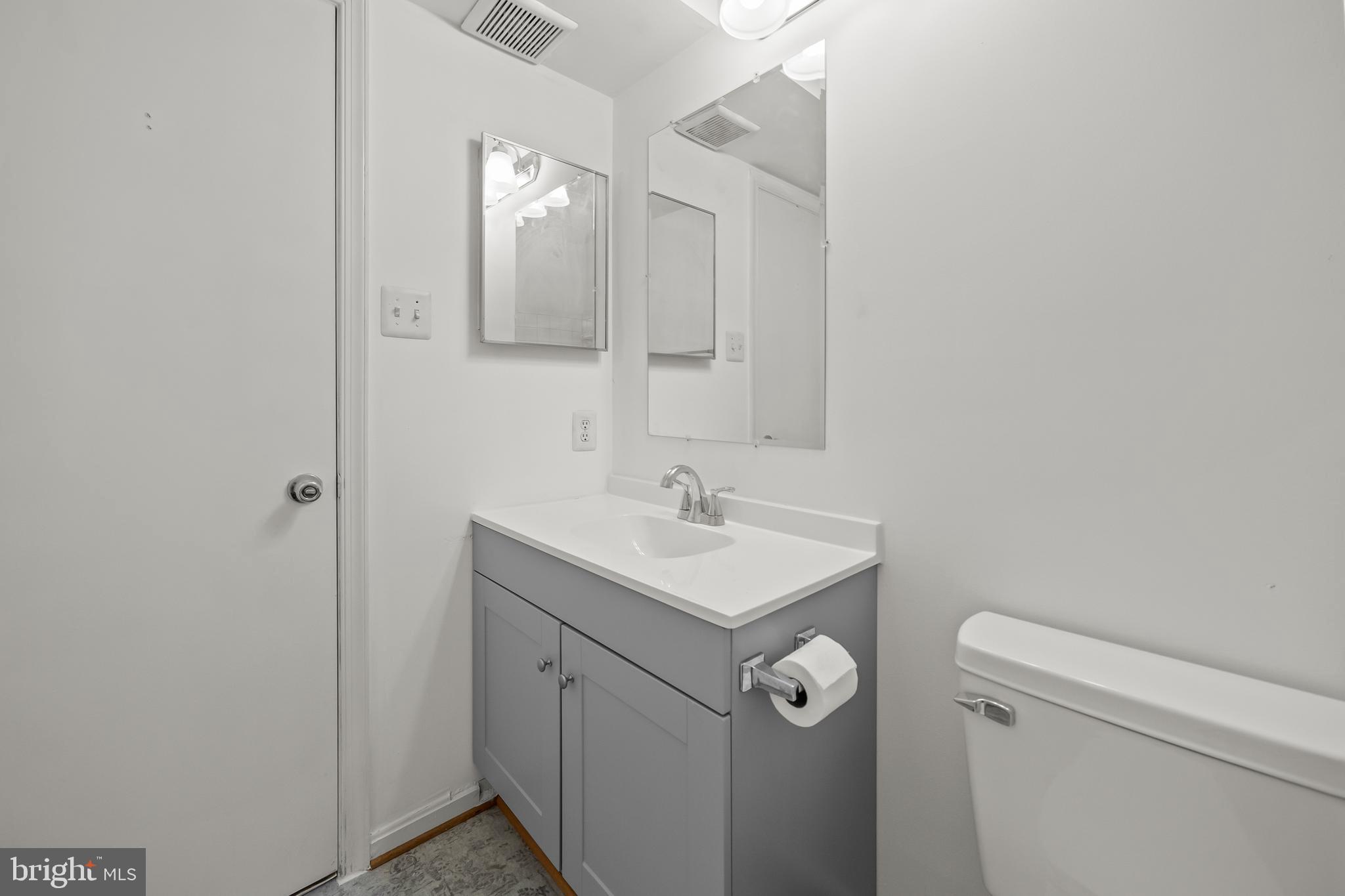 6 Normandy Square Court, Unit 2CF Silver Spring, MD 20906 - Photo 15 of 42 a bathroom with a toilet a sink and mirror