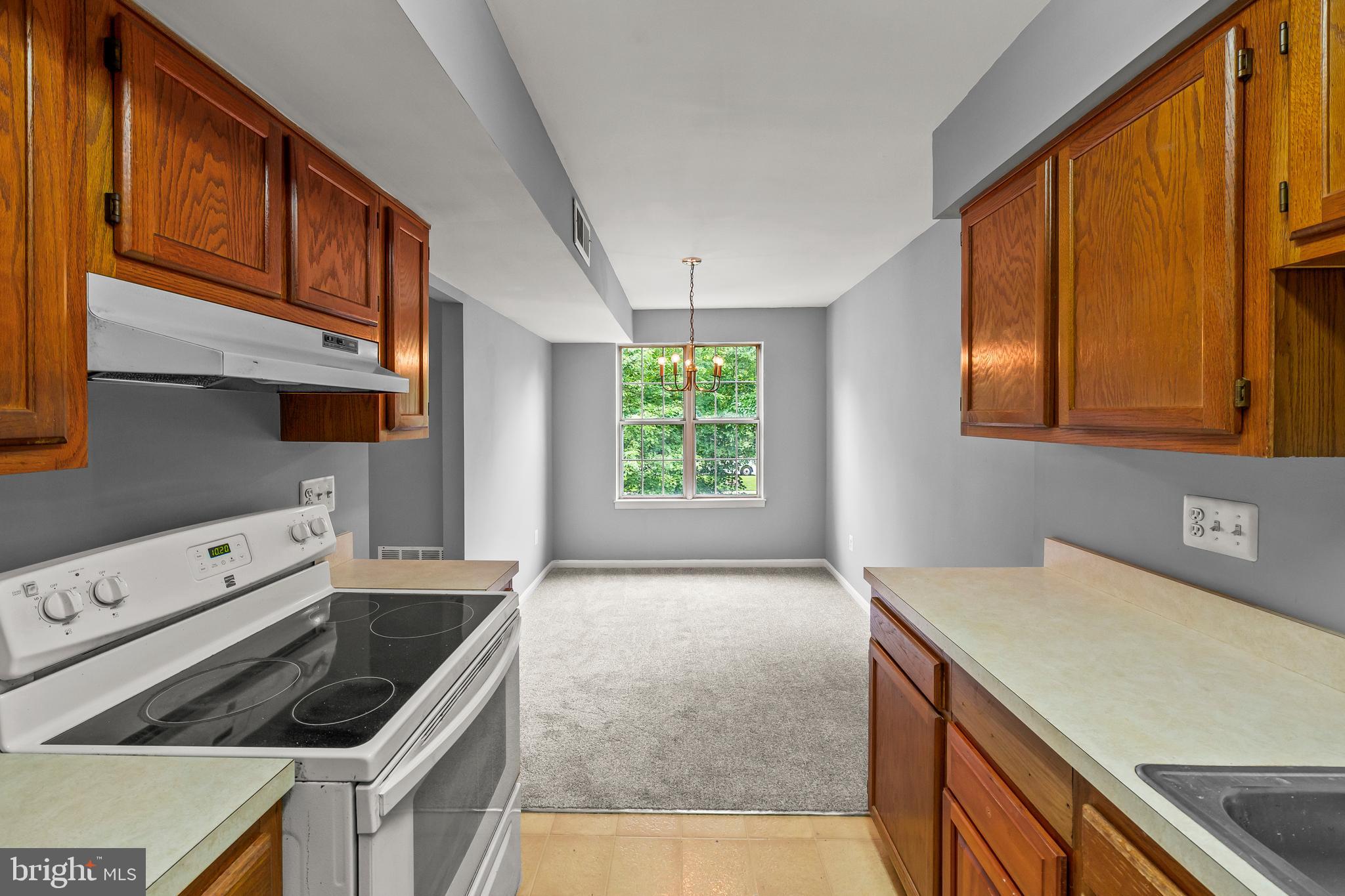 6 Normandy Square Court, Unit 2CF Silver Spring, MD 20906 - Photo 17 of 42 a kitchen with a stove cabinets and a window