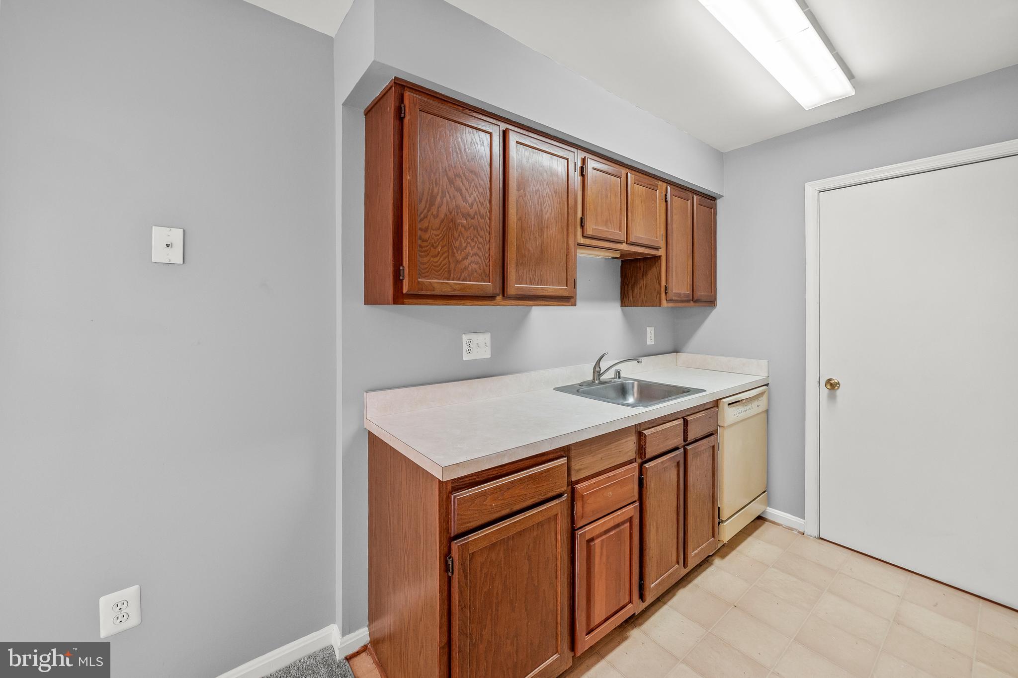 6 Normandy Square Court, Unit 2CF Silver Spring, MD 20906 - Photo 18 of 42 a utility room with a sink cabinets and a window