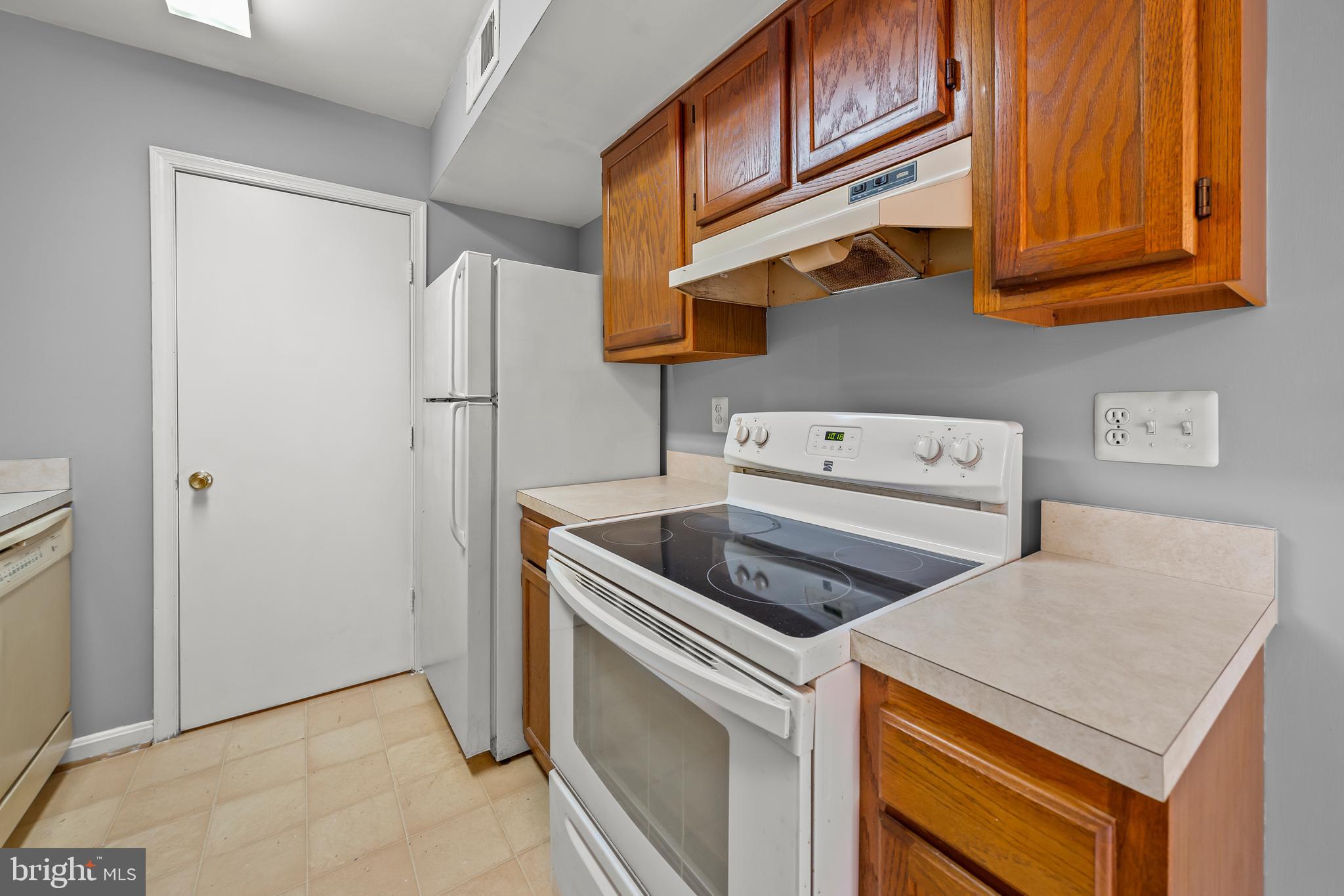 6 Normandy Square Court, Unit 2CF Silver Spring, MD 20906 - Photo 21 of 42 a kitchen with stainless steel appliances granite countertop a refrigerator and a stove