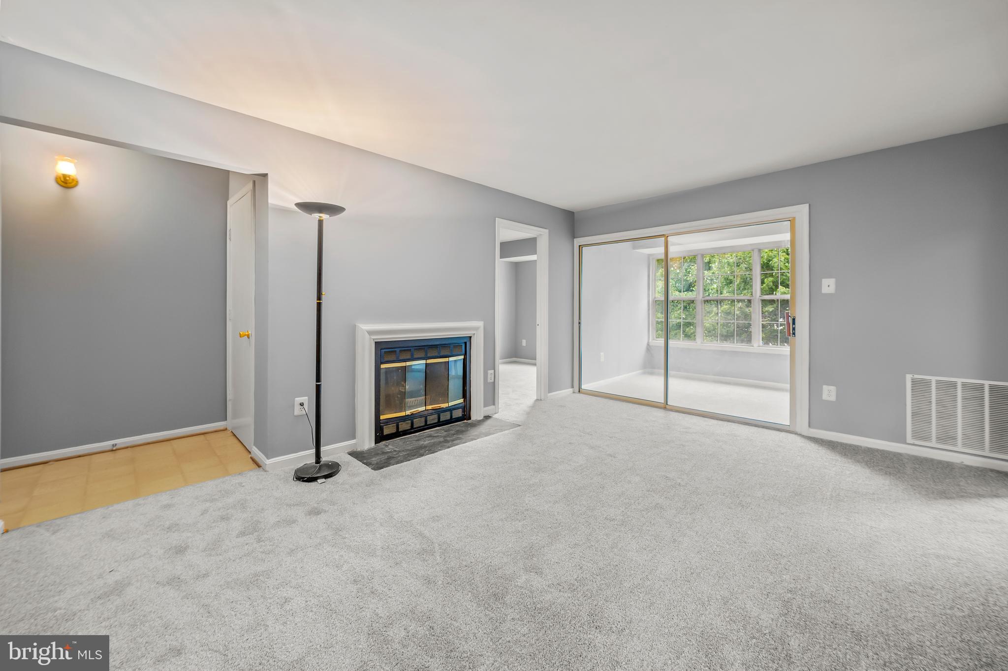 6 Normandy Square Court, Unit 2CF Silver Spring, MD 20906 - Photo 26 of 42 an empty room with windows and fireplace