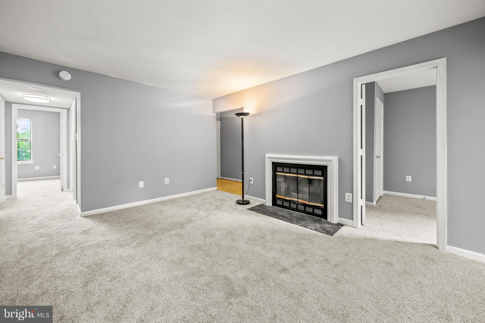6 Normandy Square Court, Unit 2CF Silver Spring, MD 20906 - Photo 5 of 42 a view of an empty room with a fireplace and a window