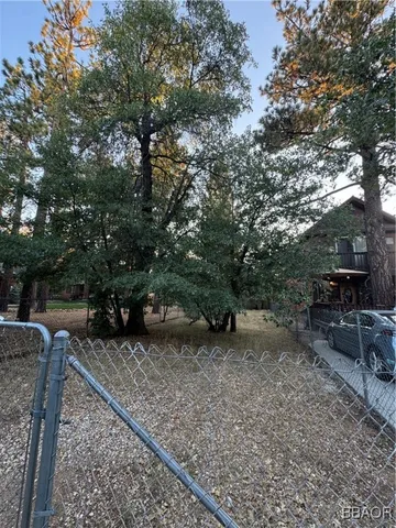 a view of a backyard with table and chairs