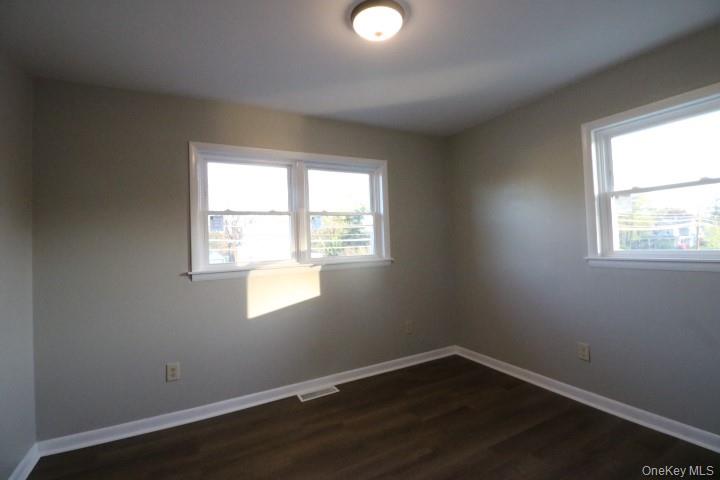 3218 Rte 9W, Unit 1 Saugerties, NY 12477 - Photo 11 of 13 an empty room with wooden floor and windows