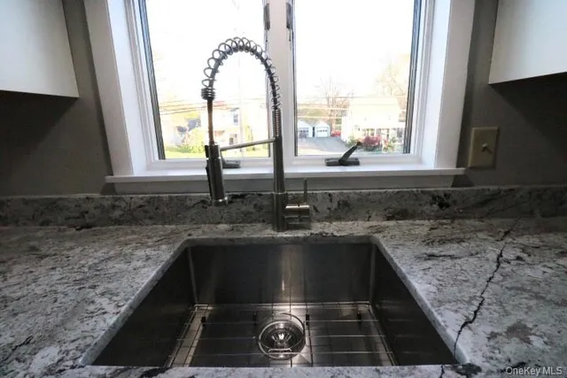 a kitchen with a sink a counter top space and a window