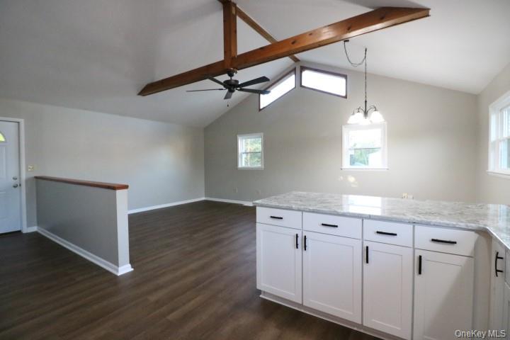 3218 Rte 9W, Unit 1 Saugerties, NY 12477 - Photo 6 of 13 a kitchen with white cabinets and chandelier