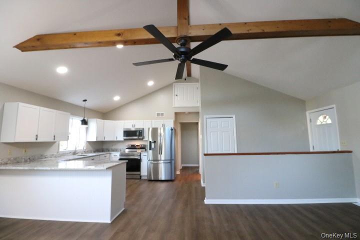 3218 Rte 9W, Unit 1 Saugerties, NY 12477 - Photo 7 of 13 a kitchen with stainless steel appliances granite countertop a refrigerator a stove and a sink with wooden floor