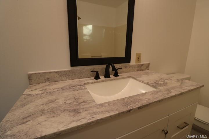 3218 Rte 9W, Unit 1 Saugerties, NY 12477 - Photo 8 of 13 a bathroom with a sink and a mirror