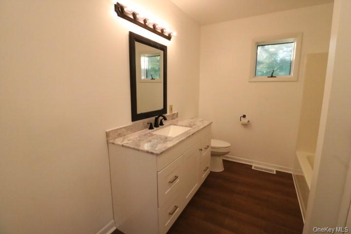 3218 Rte 9W, Unit 1 Saugerties, NY 12477 - Photo 9 of 13 a bathroom with a granite countertop sink and a mirror