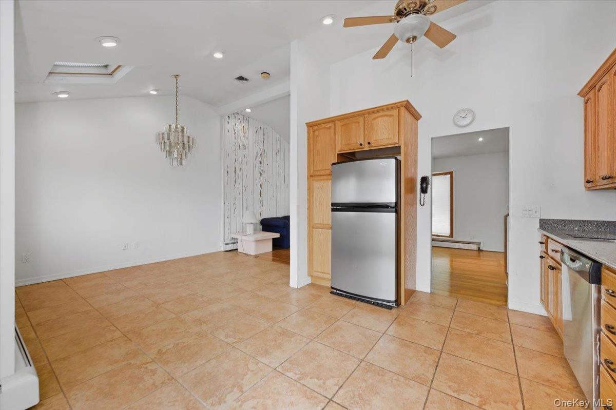 930 Jewel Drive Valley Stream, NY 11581 - Photo 11 of 32 a view of a kitchen with a sink and a refrigerator